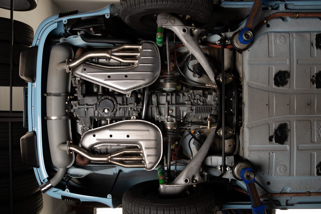 Underneath a car chasis, showing mechanical car parts